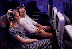 a couple watch a movie on a plane