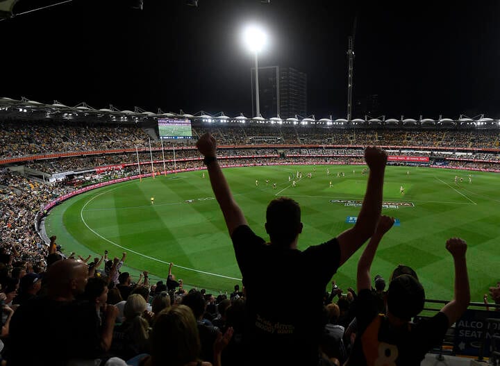 BRISBANE, AUSTRALIA - OCTOBER 24: Richmond fans celebrate at the end of the game during the 2020 AFL Grand Final match between the Richmond Tigers and the Geelong Cats at The Gabba on October 24, 2020 in Brisbane, Australia. (Photo by Ian Hitchcock/AFL Photos)