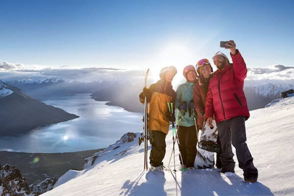 A family on a mountain with skis