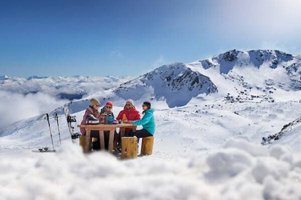 A group enjoying a drink in an outdoor ski bar