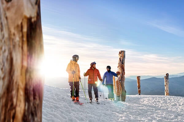 Three people standing on a New Zealand ski field