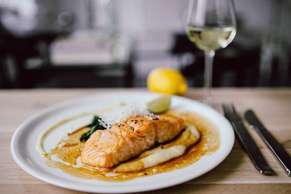 restaurant plate with salmon and wine