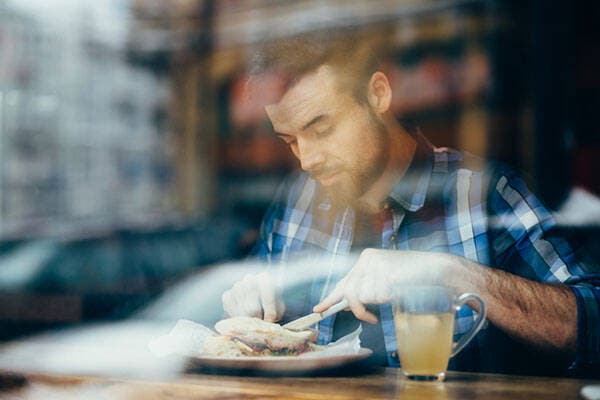 man dining in restaurant window