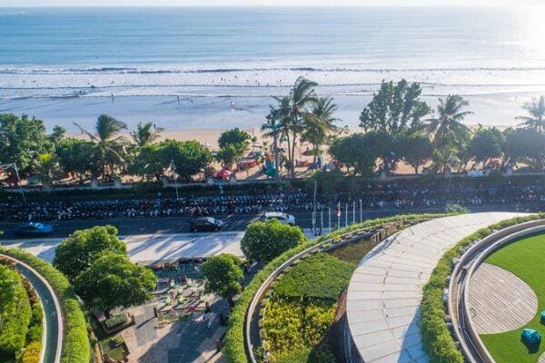 A view of the beach and palm trees from Beachwalk Bali