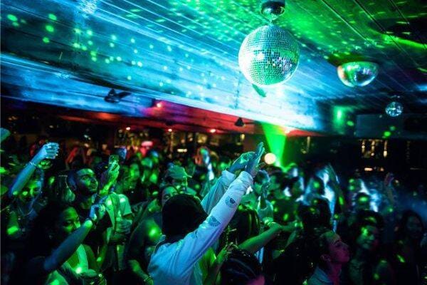 Disco balls and green laser lights while partying at Potato Head Beach Club in Bali