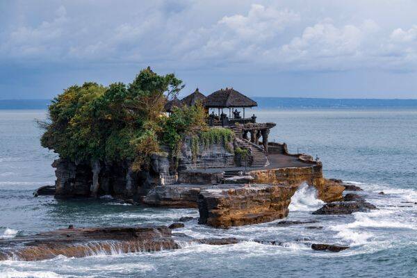 Tanah Lot Temple, Bali surrounded by sea by Nick Fewings