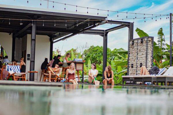 Friends hanging out at the pool at Tribe, Bali