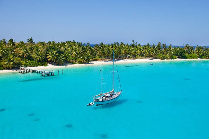 Sailing vessel in the shallow waters of Cocos Keeling Atoll, Indian Ocean