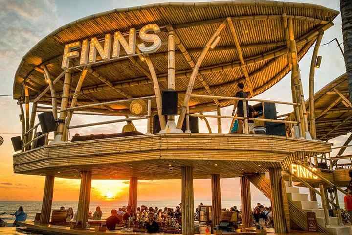 Patrons enjoying music in pool bar at Finns Beach Club Canggu, Bali