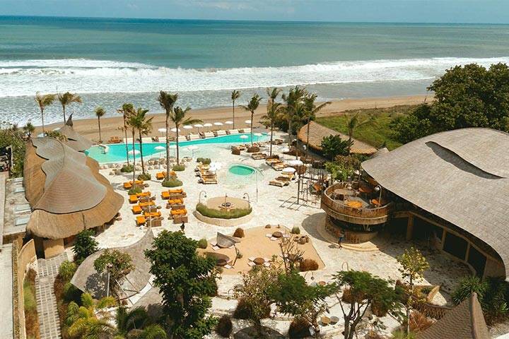 Aerial view of swimming pool and lounges at Mari Beach Club, Bali