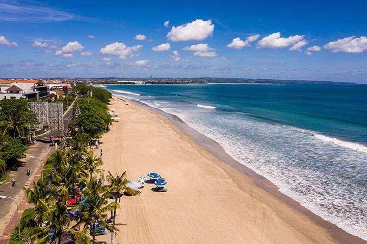Dramatic aerial view of the famous Kuta beach in Bali, Indonesia, on a sunny day