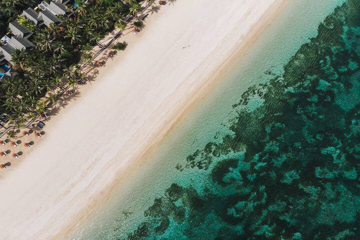 Aerial view of white sand and clear water at Nusa Dua beach, Bali