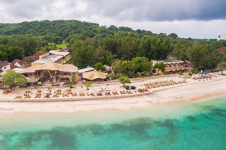 Aerial view of waves and sand of beach resort Pearl of Trawangan, Bali