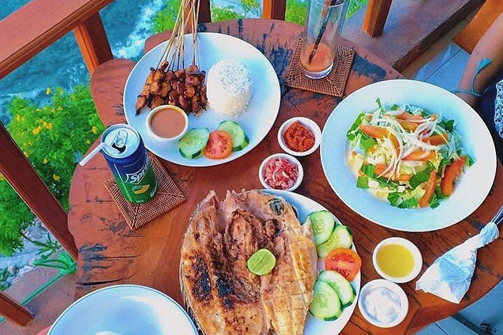 Seafood spread of food on dining table at Ogix Warung Nuse Penida, Bali