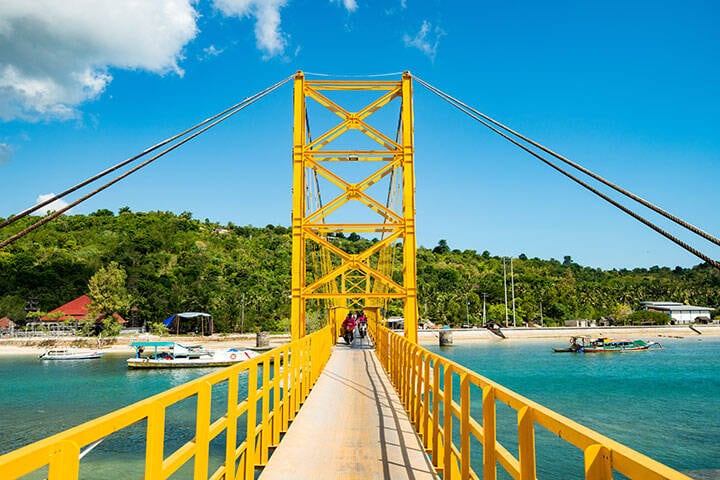 Yellow suspension bridge between Nusa Lembongan and Nusa Ceningan, near Bali
