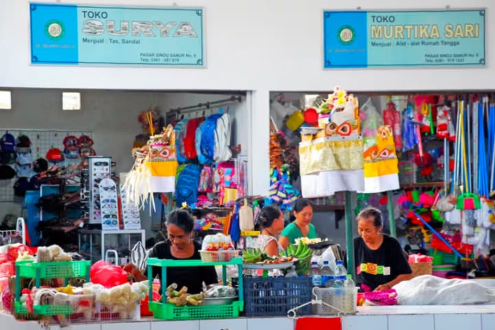 Vendors organising stock in stalls at Pasar Sindu Market, Bali