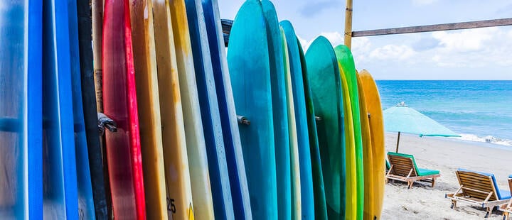 Surfboards of different color and size  are standing on a beach in Canggu, Bali
