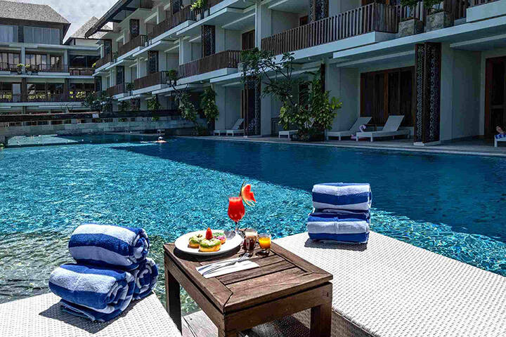 Hotel room balconies overlooking swimming pool at Swarga Suites Canggu, Bali