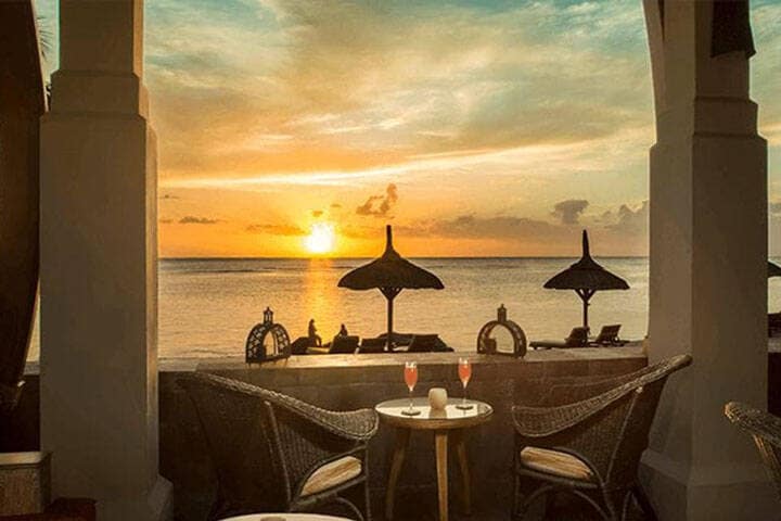 Sunset dinner on beach overlooking water at Lumbung Restaurant at The Oberoi Beach Resort, Lombok
