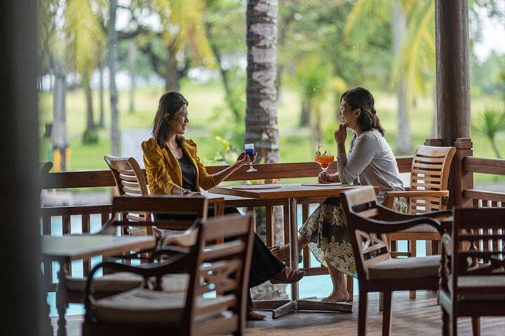 Women eating lunch in outdoor dining area on balcony at Rinjani Restaurant, Lombok