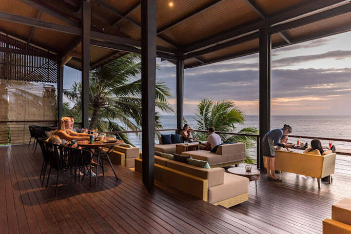 Outdoor seating area overlooking beach at The Kliff Bistro at Katamaran Resort  