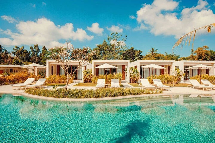 Beach cabanas overlooking blue pool at Origin Lombok