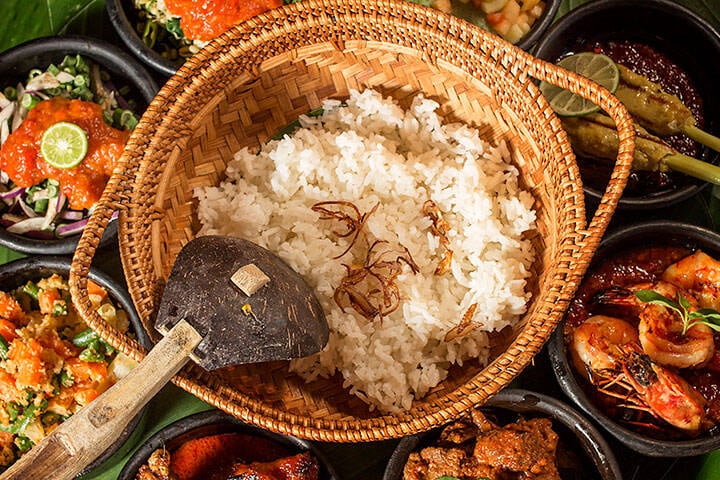 Rice dish with sides spread on bananas leaf served in Lombok restaurant at Jeeva Klui Resort