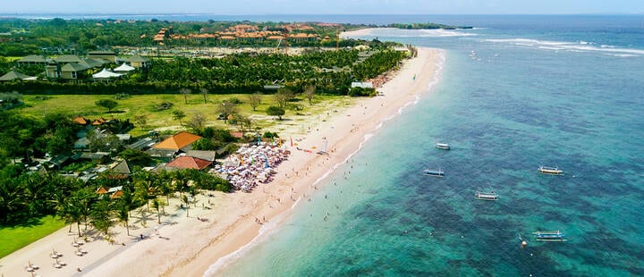 Tourists enjoying a holiday at Nusa Dua beach 