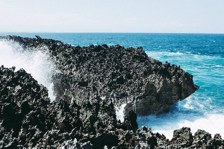 Waves crashing against rocks at the Blow Hole in Nusa Dua, Bali