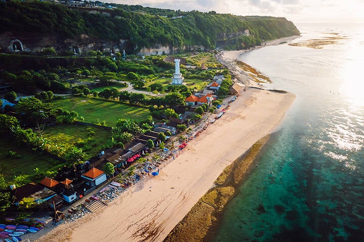 Pandawa beach with scenic landscape, lighthouse and ocean in Bali.