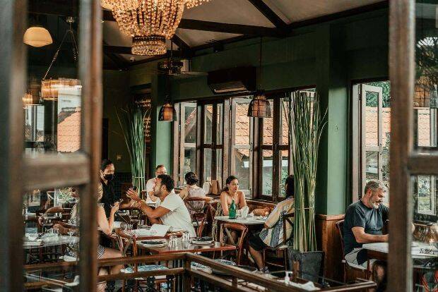 Diners eating lunch inside at Hujan Locale Ubud, Bali
