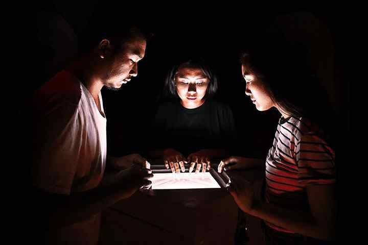 Participants in escape room reading clues in box at Pandora Experience, Kuta