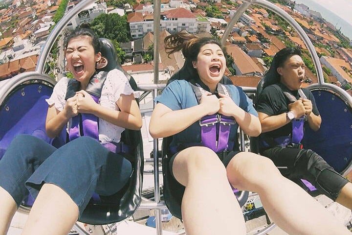Travellers airborne in bungy chair at 5XG Reverse Bungy Experience, Kuta