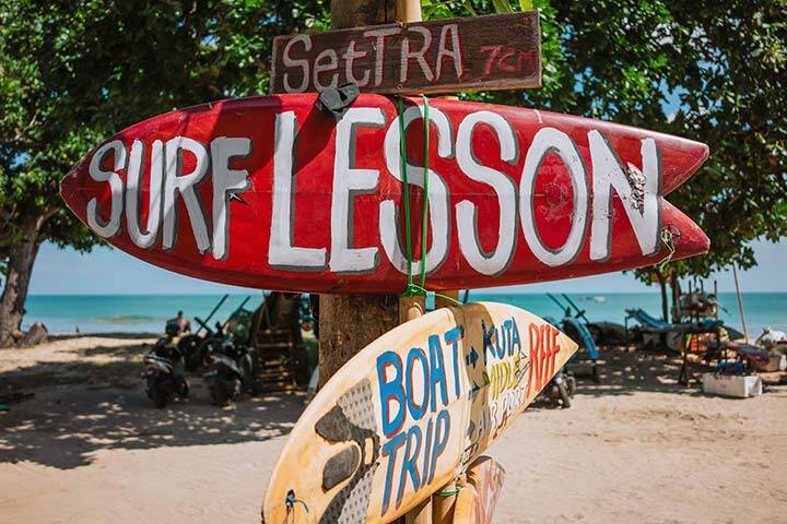 Red Surf Lesson sign at a surf school in Kuta