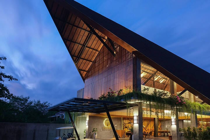 Night view of hotel lobby lit up under dark sky at Kayumas Seminyak Resort