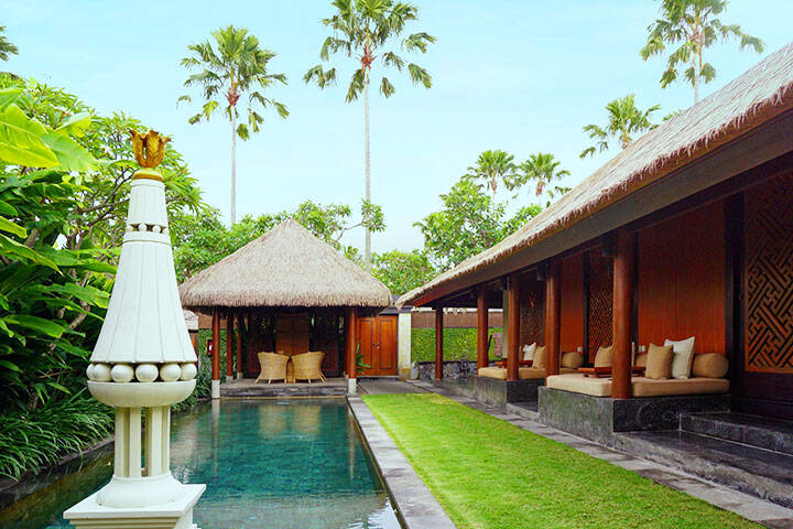 Outdoor swimming pool and lounge area in villa at The Legian Seminyak