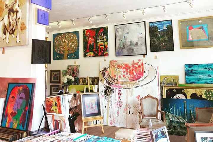 Paintings hanging on walls and easels at Purple Fine Art Gallery Seminyak, Bali