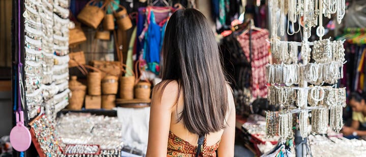 Young woman traveler at ubud market in bali