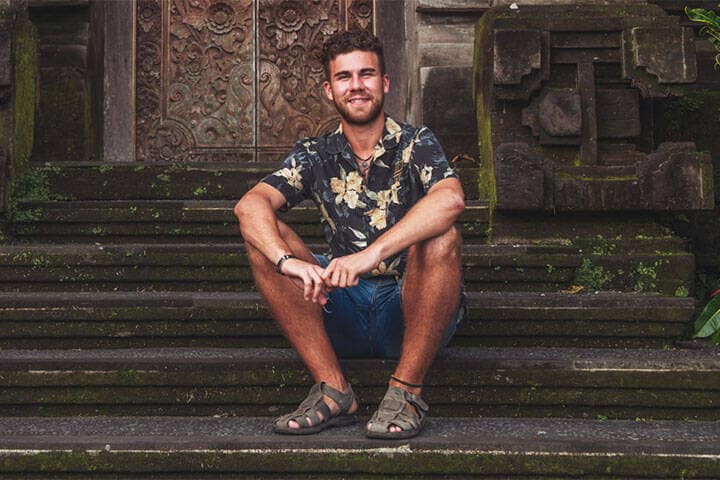 Young Man in Bali Wearing Floral Shirt, Denim Shorts and Gladiator Sandals