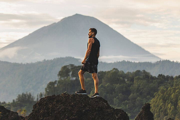 Hiking Tourist in Bali Wearing Running Shoes, Tank Top and Gym Shorts