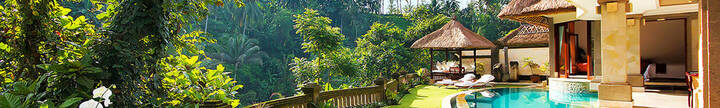 Sun loungers, garden and pool at a private villa at Viceroy Resort, Ubud, Bali