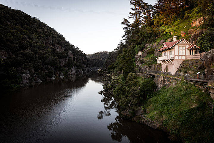 House overlooking water surrounded by lush greenery in Launceston