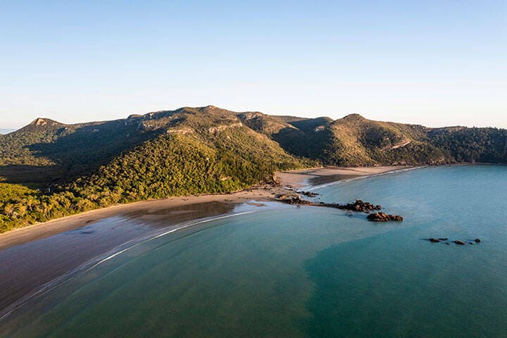Aerial view of island with green mountains in Mackay