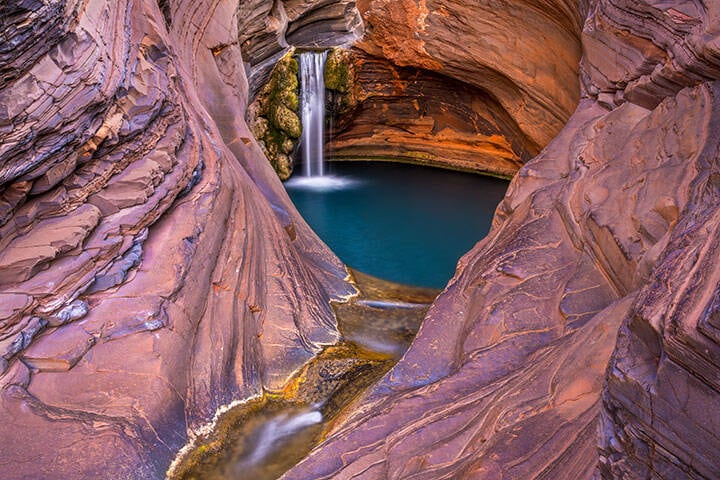 Swimming hole surrounded by orange rocks in NewmanAeri