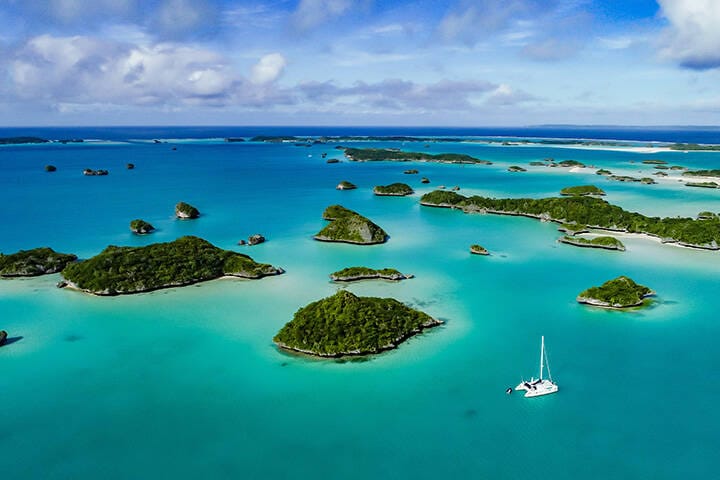 A spectacular  drone  image over Falaga Island in the lower Lau Group, Fiji showing a catamaran peacefully at anchor.