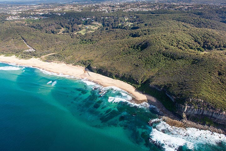 Aerial view of Dudley Beach - Newcastle Australia. This beach is surrounded by Glenrock state park and is a popular beach for local surfers and beach goers. 