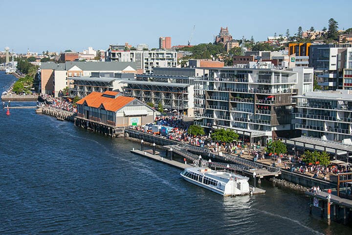 Crowds walking along the Hunter River in Newcastle. 