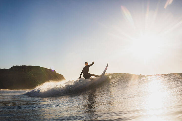 Man enjoying a morning surf at Bar Beach, Newcastle. 