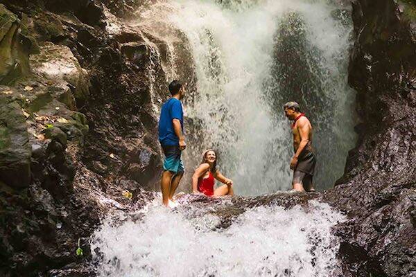 Travellers hiking on waterfall in Samoa