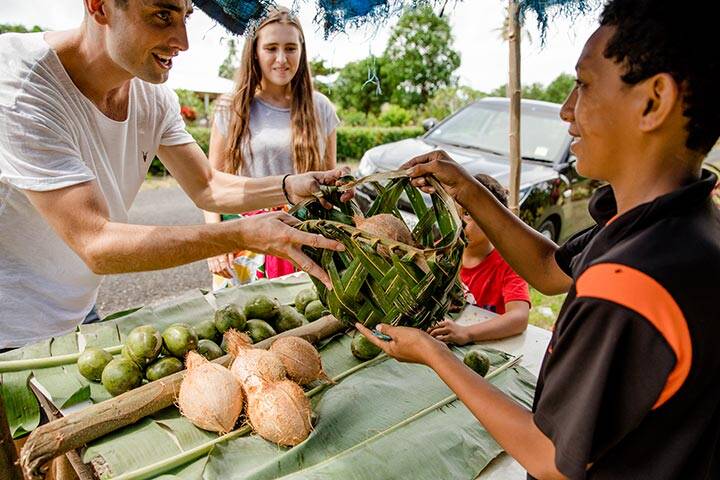 Tourists interacting with Samoan locals